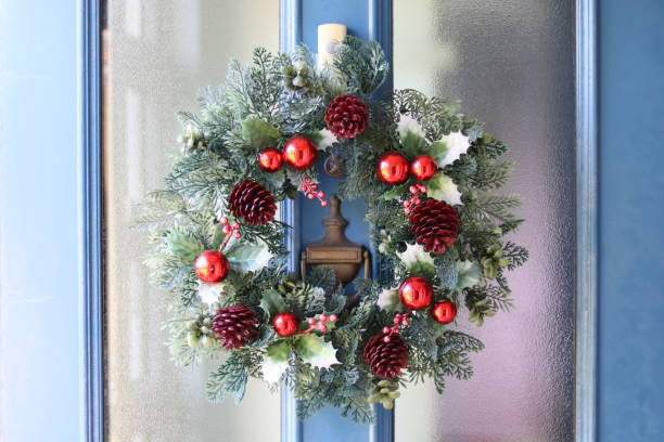 istock christmas wreath on wooden door 1084636662
