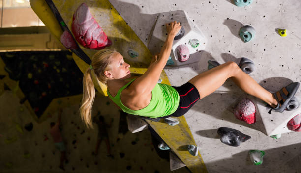 istock Woman on climbing wall without belay in dark 1084637194