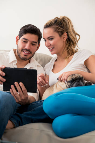 istock Couple with their pet and tablet 1084640218