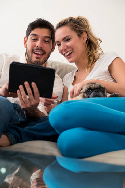istock Couple with their pet and tablet 1084643784