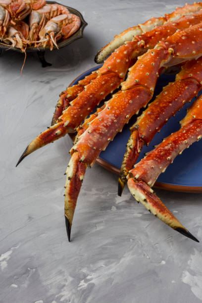 istock King Crab claw on blue plate at gray background 1084644696