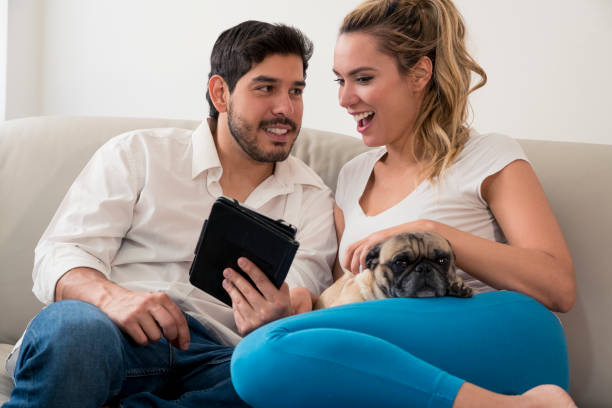 istock Couple with their pet and tablet 1084644962