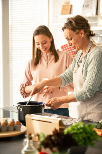 istock Mother preparing healthy food 1084648090