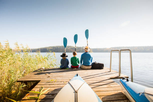 Father and two sons playing on pier Family Autumn season activities around lake. Kayaking. Posing with oar. shoulder stand stock pictures, royalty-free photos & images