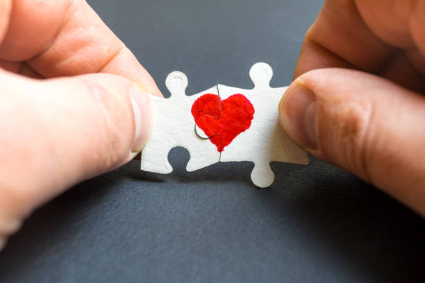 istock Symbol of love. Heart drawn on two puzzles. 1084659666