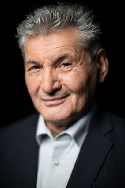 istock Confident senior businessman on black background 1084663548