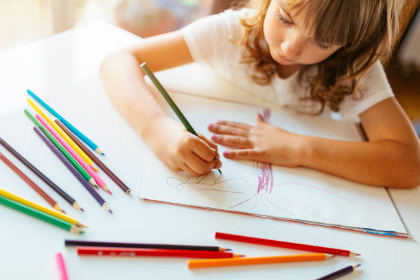 istock Cute girl coloring 1084664102