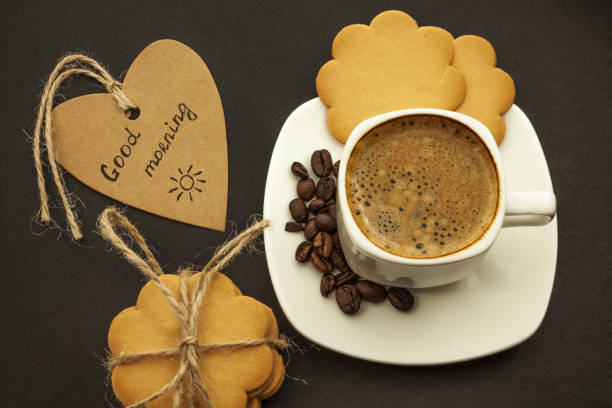 istock Black coffee with coffee beans and cookies on a dark background. Breakfast, top view. 1084666230
