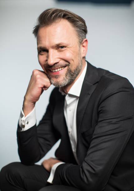 istock Businessman smiling with hand on chin. 1084666674