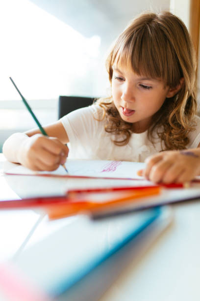 istock Little girl drawing at home 1084666684