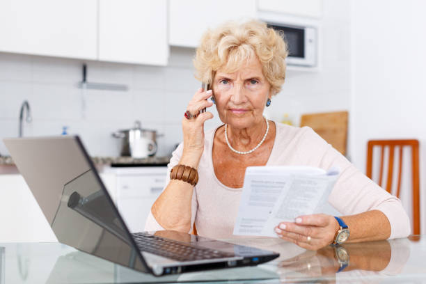 istock Woman talking on phone, using laptop 1084666846