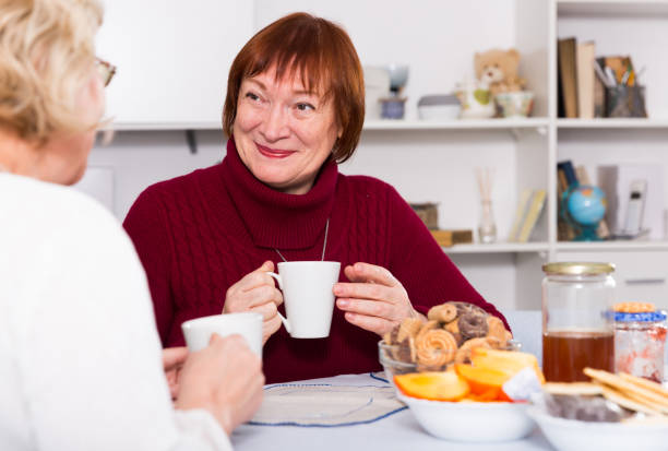 istock Positive old women drinking tea at the table 1084670082