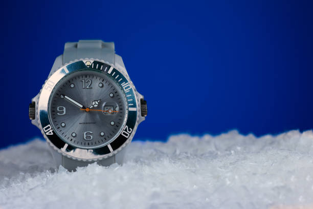 istock Frozen silver wristwatch on snowy background with copy space 1084670670