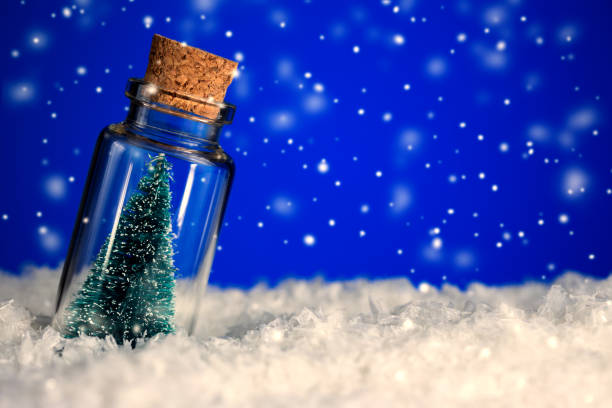 istock Christmas Tree in bottle on snowy blue background with copy space 1084670832