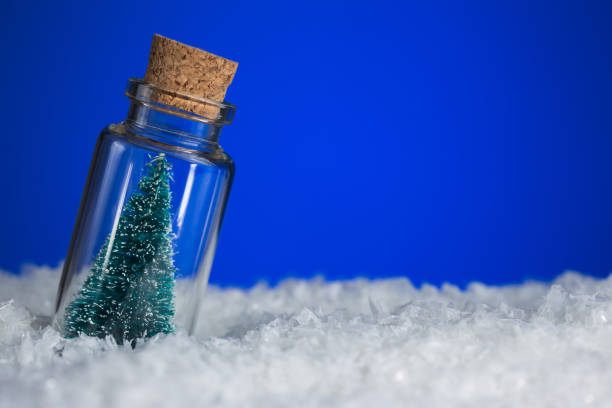 istock Christmas Tree in bottle on snowy blue background with copy space 1084670834