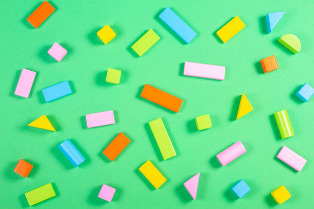 istock Colorful wooden cubes pattern on green color background 1084671460