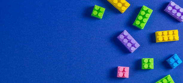istock Baby kid toys background. Colorful plastic construction blocks on blue background 1084671598