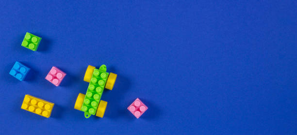 istock Colorful plastic toy car building blocks on blue background 1084671648
