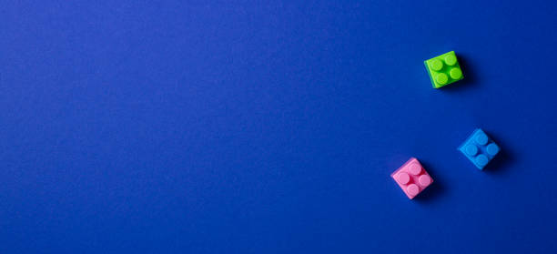 istock Baby kid toys background. Colorful plastic construction blocks on blue background 1084671670