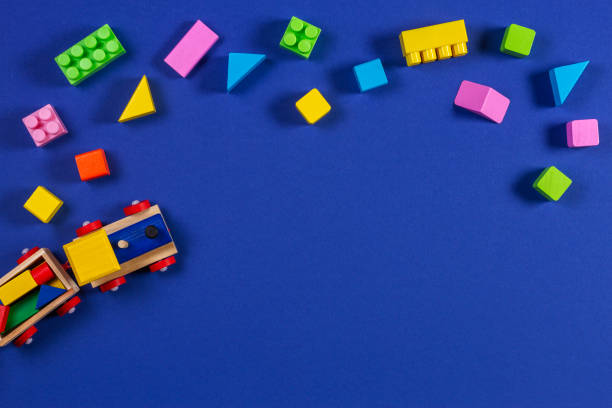 istock Wooden toy train with colorful cubes on blue background 1084671808