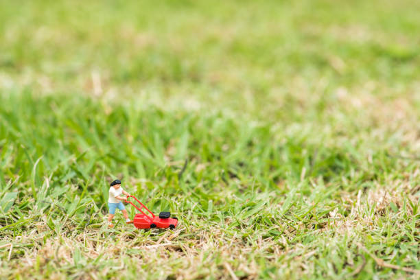 istock Small Figurine On Grassy Field 1084673164
