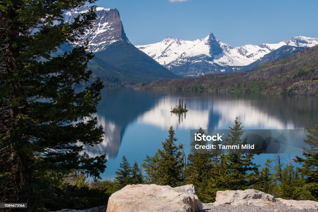 Snowcapped mountain reflection lake Snow capped mountain reflection body blue water. Small island pine trees Beauty In Nature Stock Photo