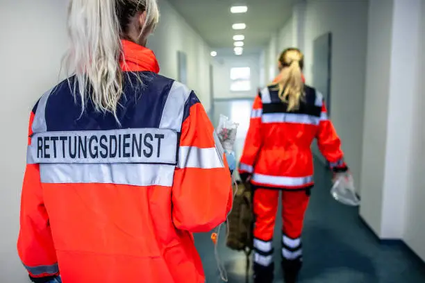 German paramedic runs in a floor to an accident. The german word RETTUNGSDIENST means emergency service