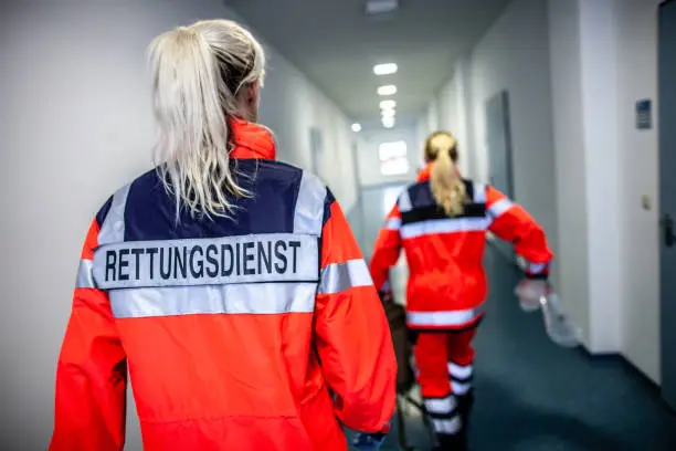 German paramedic runs in a floor to an accident. The german word RETTUNGSDIENST means emergency service