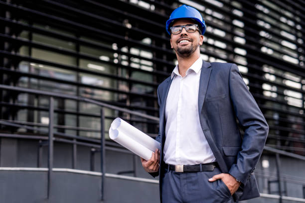 istock Happy young African American architect looking at a construction site. 1084674648