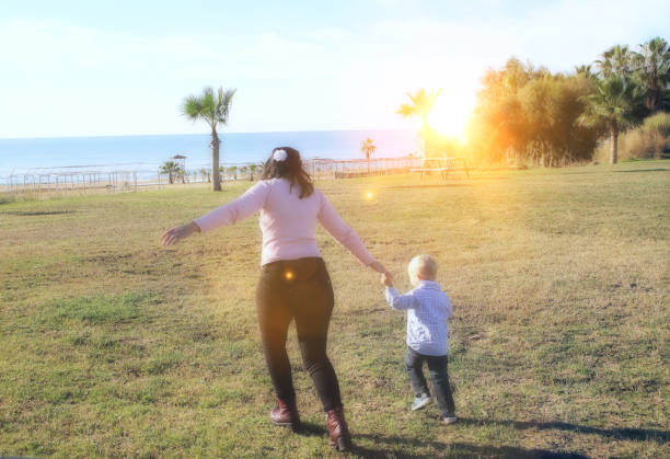 istock mother and son running to the beach 1084675166