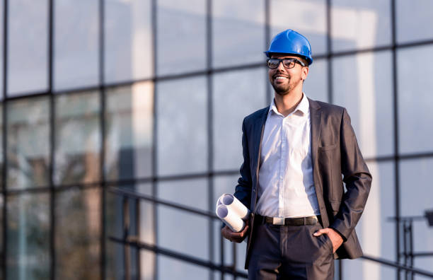 istock Happy young African American architect looking at a construction site. 1084675434