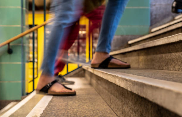 istock Low Section Of Woman Walking On Staircase 1084687952