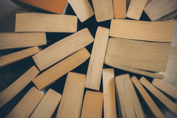 istock Stack of old books background. Top view of many books piled together. Education and wisdom concept. 1084688564