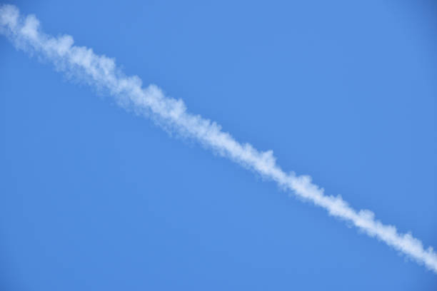 istock Low Angle View Of Vapor Trail In Clear Blue Sky 1084691736