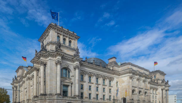 istock Reichstag building in Berlin, Germany. Under view, cloudy sky background. 1084693672