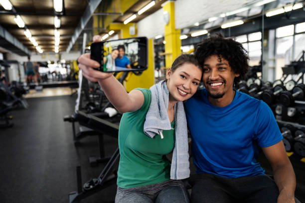 istock Couple taking selfies in the gym 1084695046