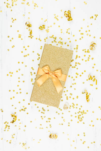 istock Golden gift box with confetti 1084699472
