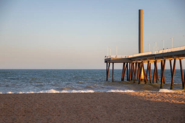 istock pier on the beach with waves and blue sky (costa azul, rio das ostras, rio de janeiro, brazil) 1084699646