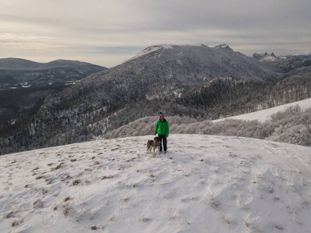 istock Man and his dog on a winter walk 1084702512