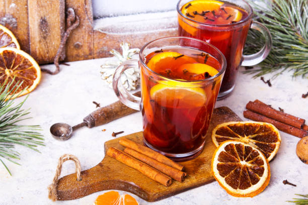 istock Christmas drink, mulled wine with orange, cinnamon and cloves on white background 1084707822