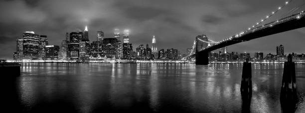 Manhattan Skyline at night New York, US, 07/15/1999: Manhattan Skyline at night with fog from the Brooklyn Heights Promenade with the twin towers in the middle and the Brooklyn Bridge on the right twin towers manhattan stock pictures, royalty-free photos & images