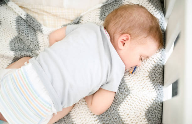 istock Newborn baby sleeping peacefully in crib. 1084708904