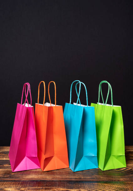 Multi colored shopping bags on black background stock photo