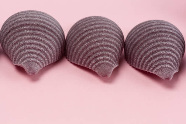 istock Extreme closeup of pasta shells on pink background 1084718890