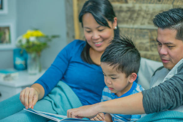 istock Parents reading to their son in bed 1084721674