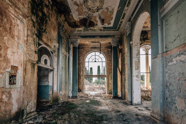 istock Ruined large hall interior overgrown by plants and moss 1084723742