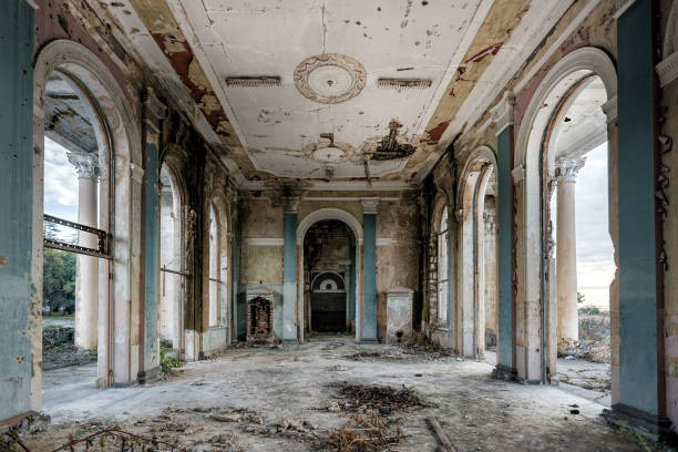 istock Ruined large hall interior overgrown by plants and moss 1084723750