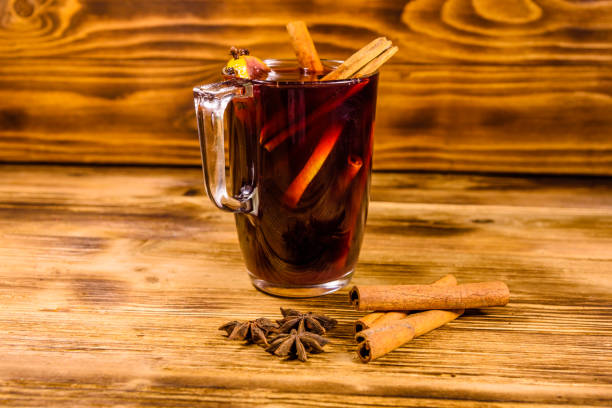 istock Cup of mulled wine with cinnamon on wooden table 1084724880