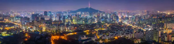 Panoramic view over the landmarks and lights of Seoul, Korea's crowded and colourful capital city, from the ancient fortress walls across the futuristic neon lights of downtown, past the iconic spire of Seoul Tower on Namsan mountain to the modern high rises of Gangnam and beyond.