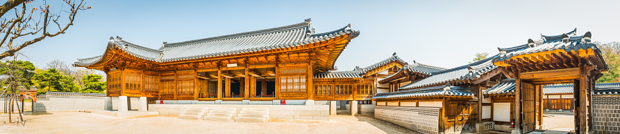 The ornately carved wooden eaves of a traditional pagoda hall at Deoksugung in the historic heart of Seoul, South Korea.